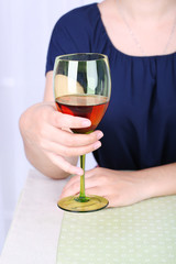 Young woman with glass of red wine