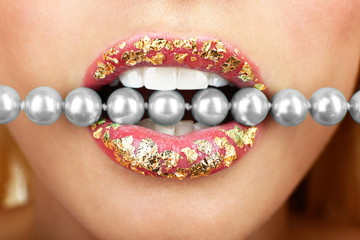 Necklace in teeth, close up