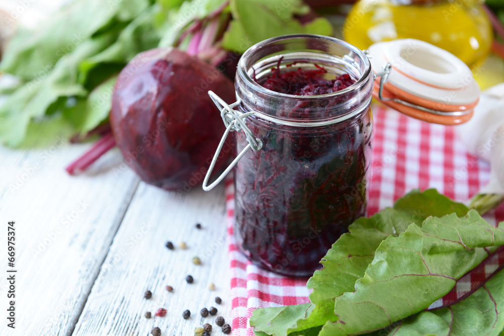 Sticker Grated beetroots in jar on table close-up