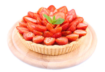Strawberry tart with green mint leaves isolated on white