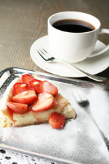 Piece of strawberry tart on  tray, on rustic wooden background