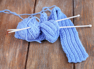 Yarns for knitting on wooden table close-up