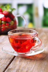 Fruit red tea with wild berries in glass cup,