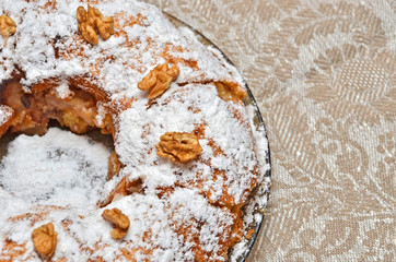 Round homemade biscuit cake on plate and napkin
