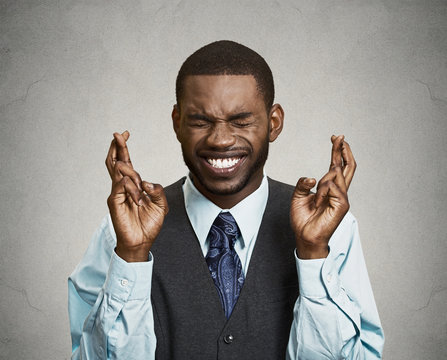 Man, corporate executive crossing his fingers, hoping for best - Powered by Adobe