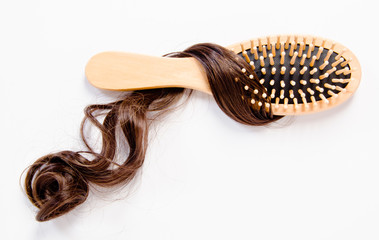 wooden comb brush with hair.