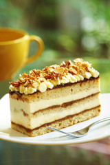 close up coffee cake and nut in white dish