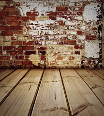 Empty wooden floor and bricks wall