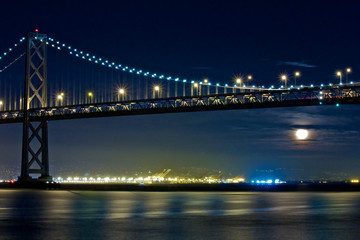 Fototapeta na wymiar Moon Rising Under San Francisco Bay Bridge
