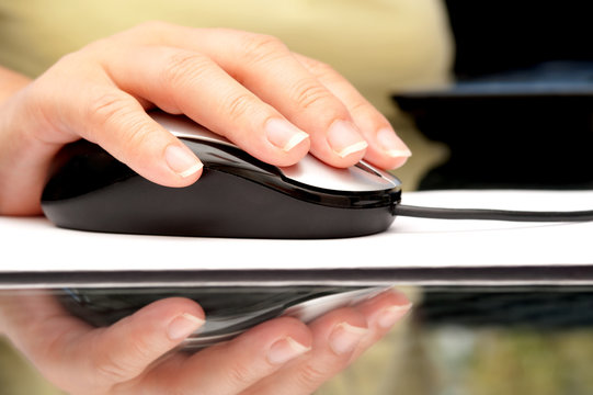 Woman hand using computer mouse
