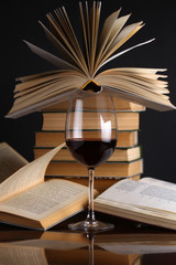 Wine glass and books