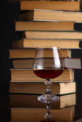 Glass of brandy and books