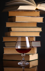 Glass of brandy and books
