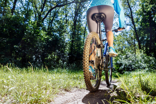 Young Woman On Mountain Bike Fast Ride Outdoors.