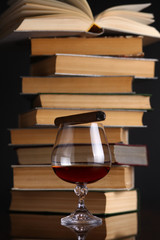 Glass of brandy and books
