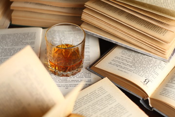 Glass of whiskey on books
