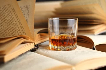 Papier Peint photo Alcool Glass of whiskey on books