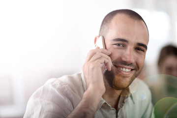 Cheerful salesman talking on the phone