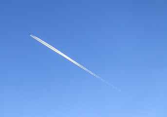 contrail in a blue and orange sky
