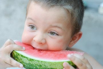 Boy eating watermelon red