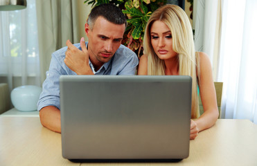 Young couple using laptop together