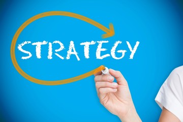 Businesswoman writing the word strategy