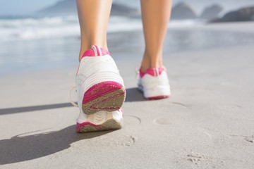 Fit woman walking on the beach