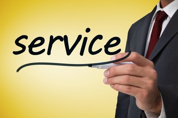 Businessman writing the word service