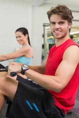Smiling man working out on the rowing machine