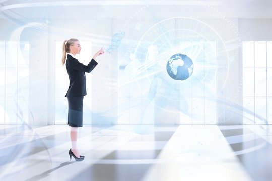 Composite image of businesswoman pointing somewher