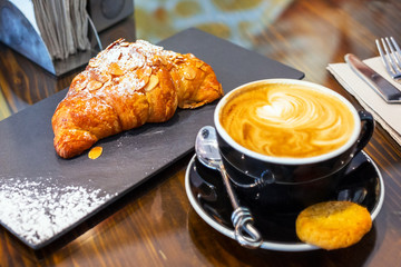 Coffee break with fresh croissant 