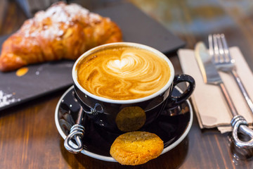 Coffee break with fresh croissant 