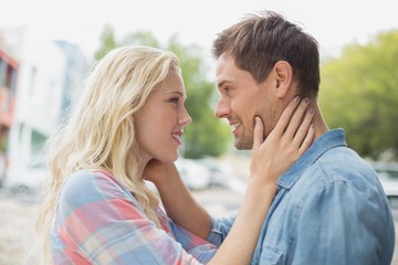 Hip young couple smiling at each other