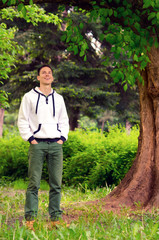 Fototapeta premium Handsome smiling man in the forest