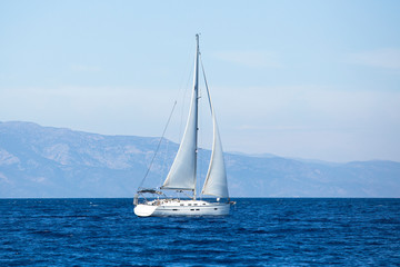 Obraz premium Sailing ship yachts with white sails in the sea.