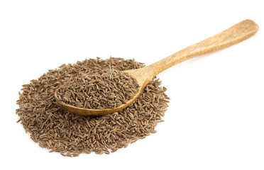 cumin seeds in spoon on white
