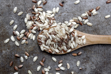 Red, brown and white rice on table