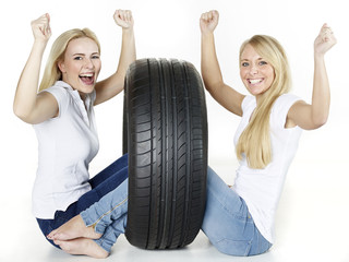 Two girls with tire sitting on the floor