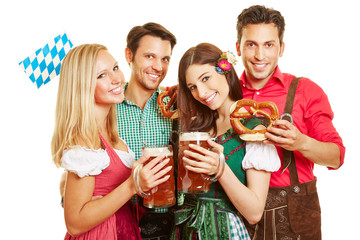 Freunde beim Oktoberfest feiern in Dirndl und Lederhose