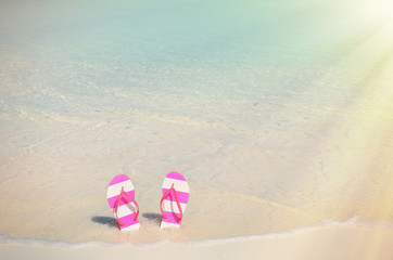 Fototapeta na wymiar Flip-flop on the beach