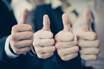 Group of hands with thumbs up expressing positivity