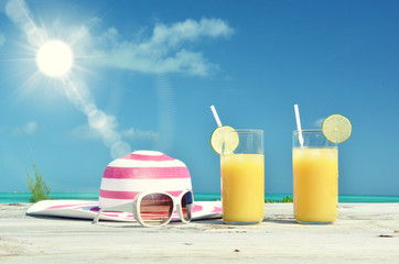 Sunglasses, hat and orange juice