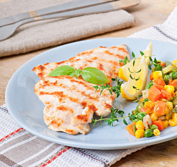 Grilled chicken breasts and vegetables