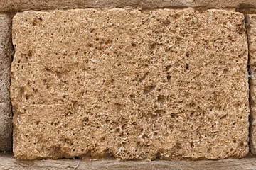 Photo sur Plexiglas Pierres block of tuff on wall of medieval palace