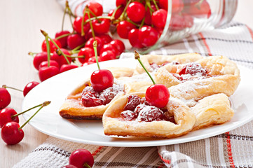 Tasty puff with a sweet cherry