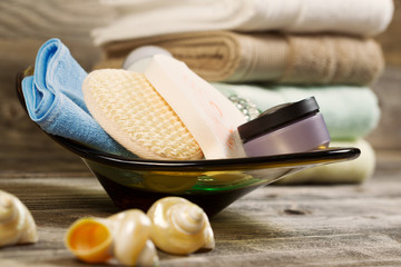 Spa Hygiene Accessories in Glass Bowl on Rustic Wood