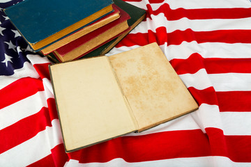 Fototapeta premium Vintage open book on American flag