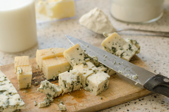 Blue cheese cutted on wooden plate
