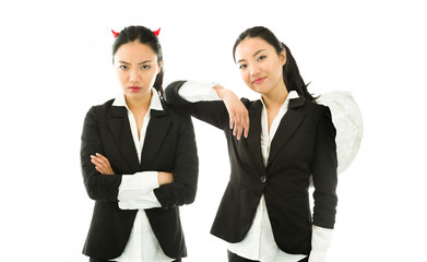 Angel and devil sides of a young Asian businesswoman isolated on