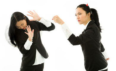 Angry devil side of a young Asian businesswoman punching the